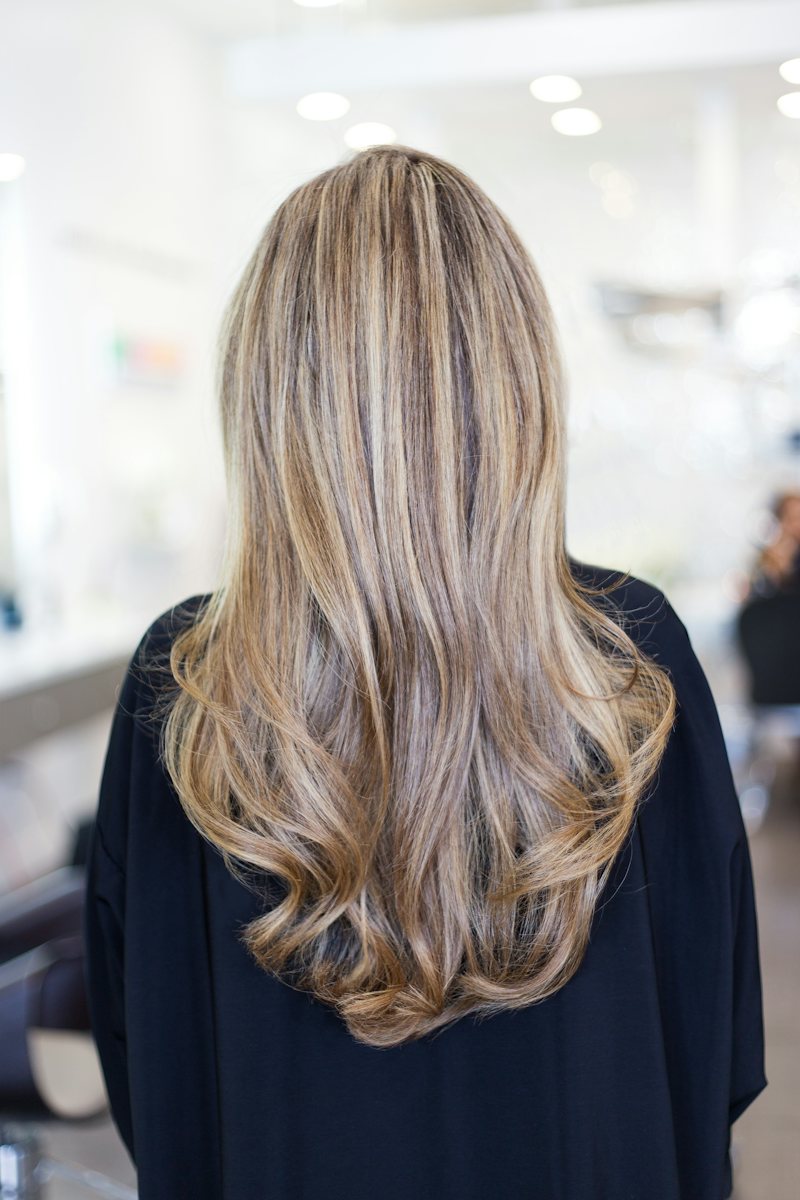 Long hair with blended blonde balayage, seen from behind